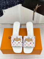 White logo slide sandals with multicolor patterned strap and flat sole