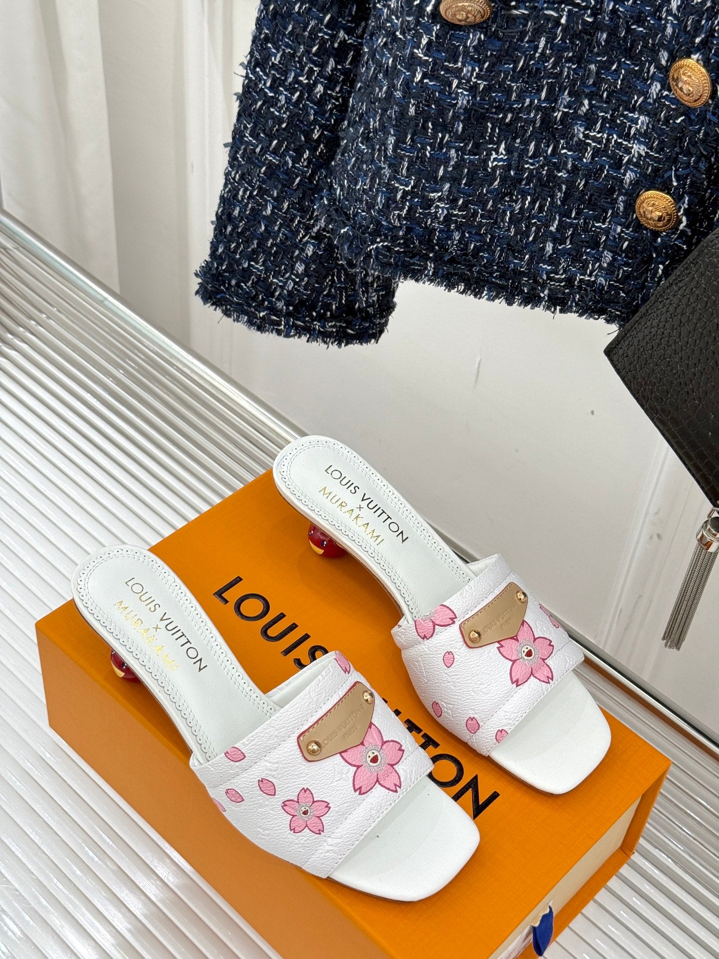 White women's slide sandals with pink flower print and gold strap hardware