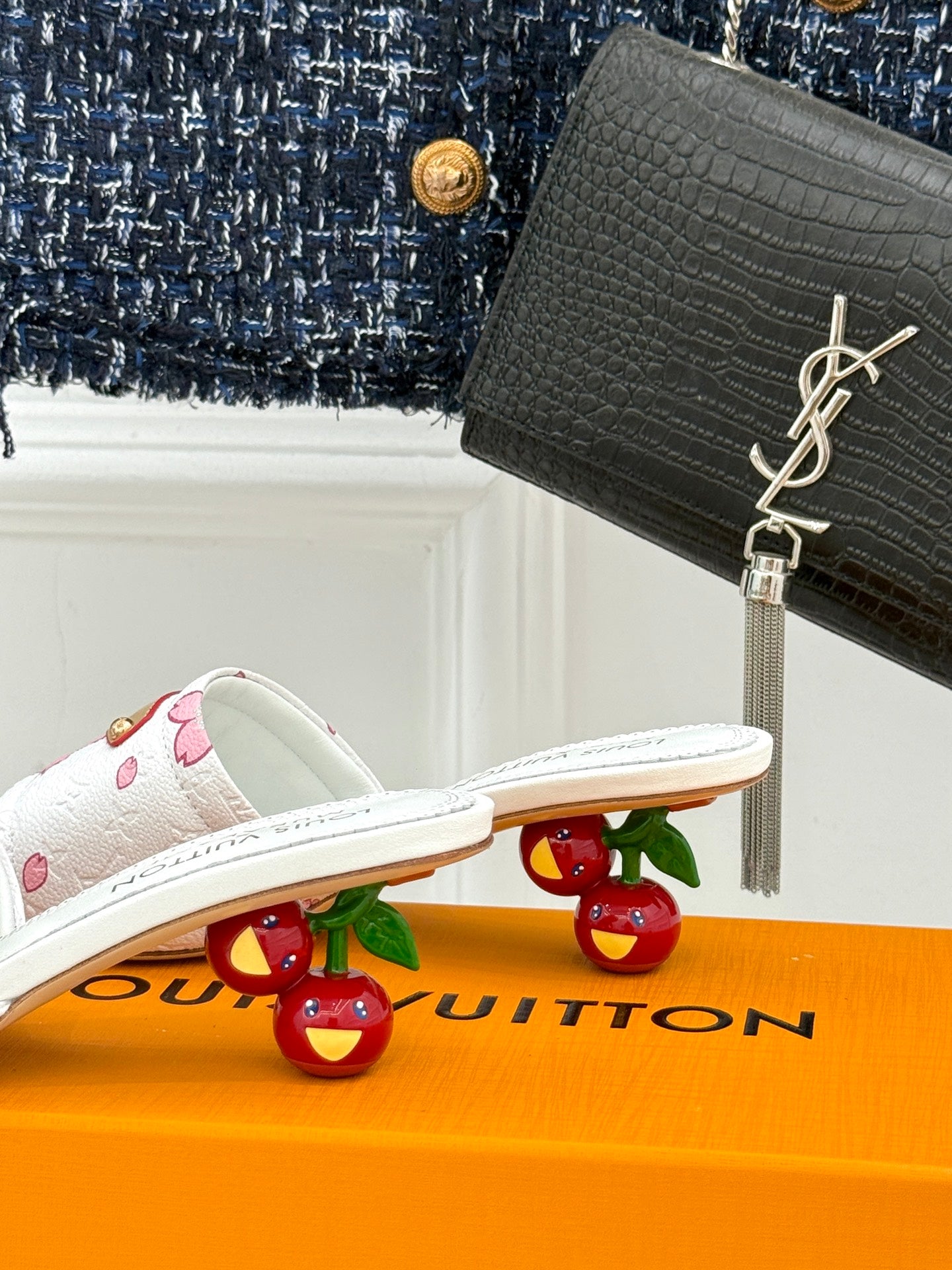 White slide sandals with pink flower print and gold buckled strap