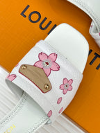 White slide sandal strap with pink flower print and gold buckle detail