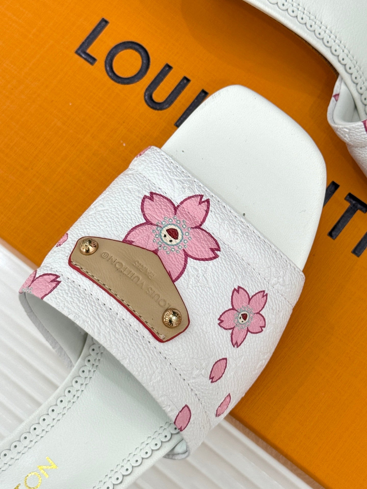 White slide sandal strap with pink flower print and gold buckle detail