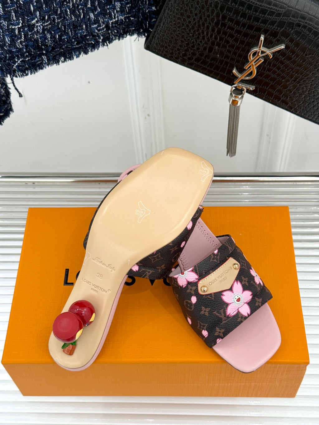 Louis Vuitton slide sandals with pale pink sole and floral black strap upper