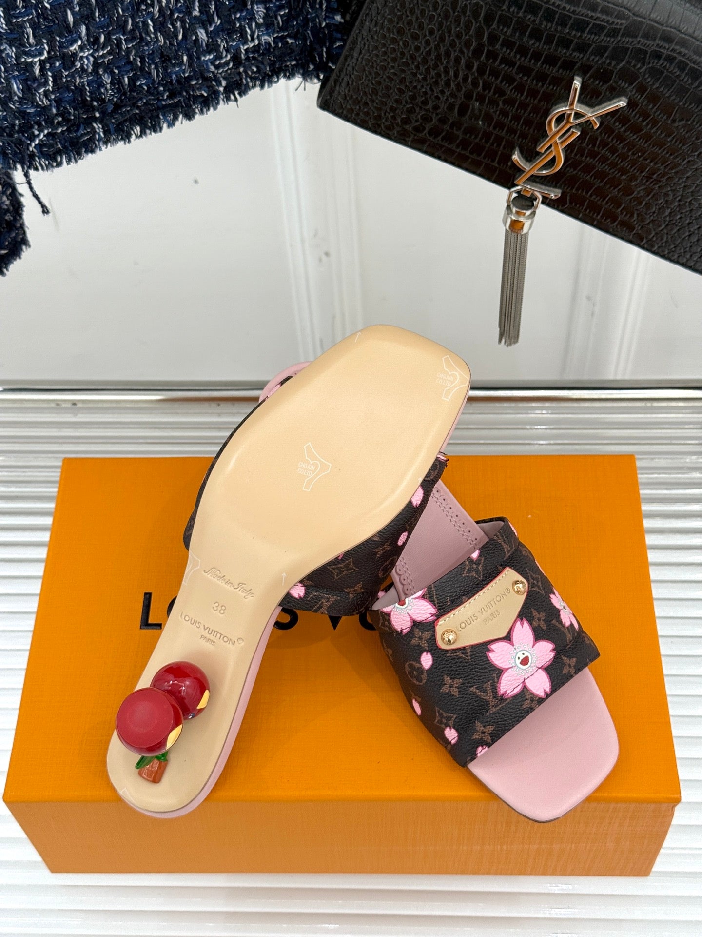 Louis Vuitton slide sandals with pale pink sole and floral black strap upper