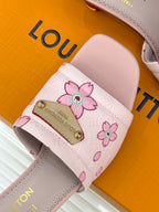Louis Vuitton ladies pink floral slide sandal strap close-up with gold logo plaque