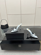 Women’s YSL light blue mule sandals, pair with pointed toe and stiletto heels on box