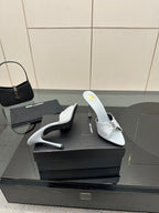 Women’s YSL light blue mule sandals on black box, pointed toe and stiletto heel