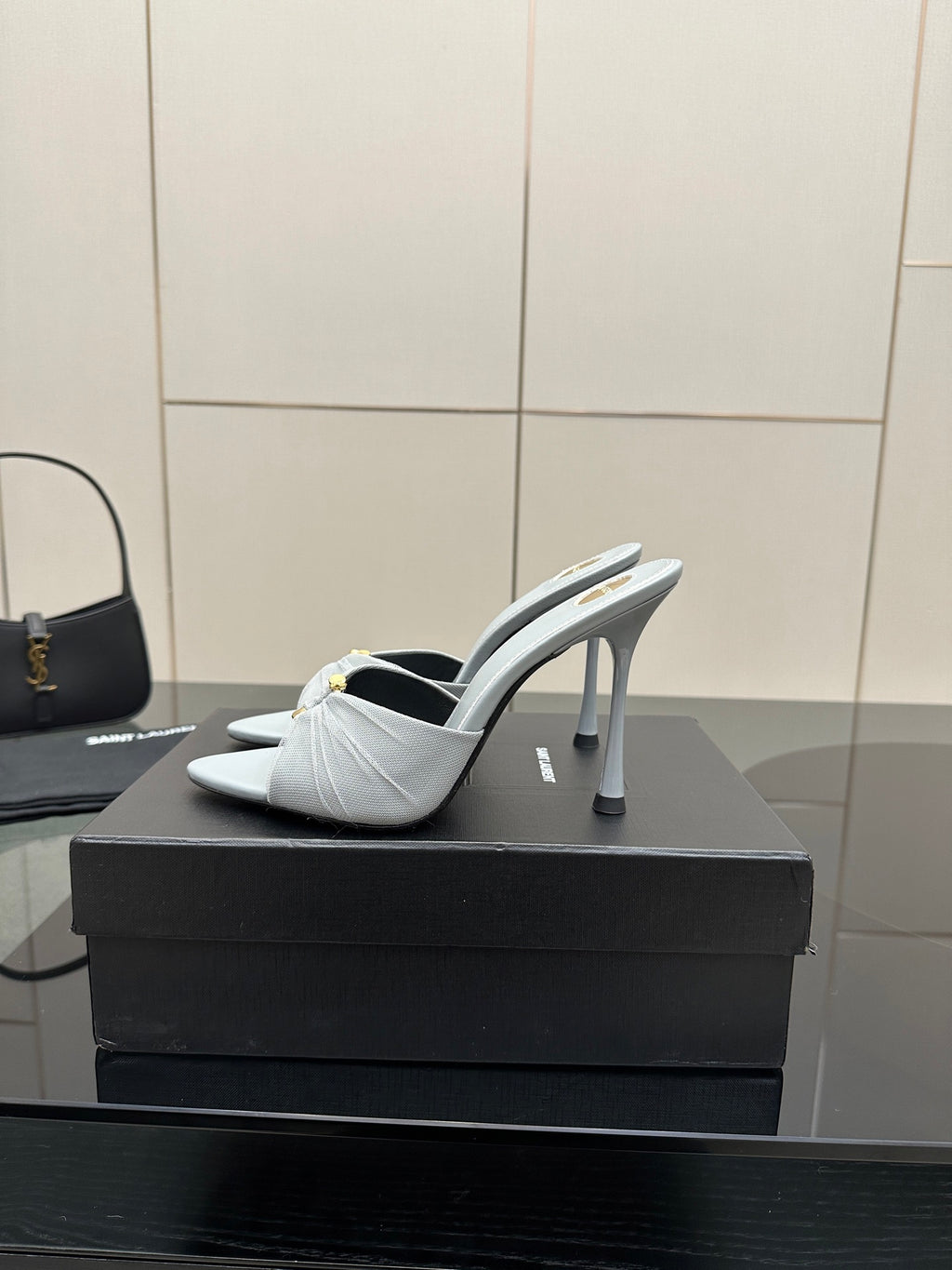 Women’s YSL light blue mule sandals, side view with thin stiletto heel and bow-knot detail