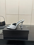 Women’s YSL light blue mule sandals, side view with thin stiletto heel and bow-knot detail