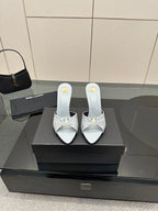 Women’s YSL pointed-toe mule sandals, light blue with stiletto heel and knot strap