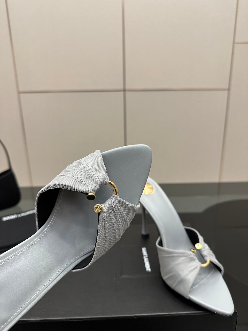 Women’s YSL light blue mule sandals, close-up of back strap and stiletto heel