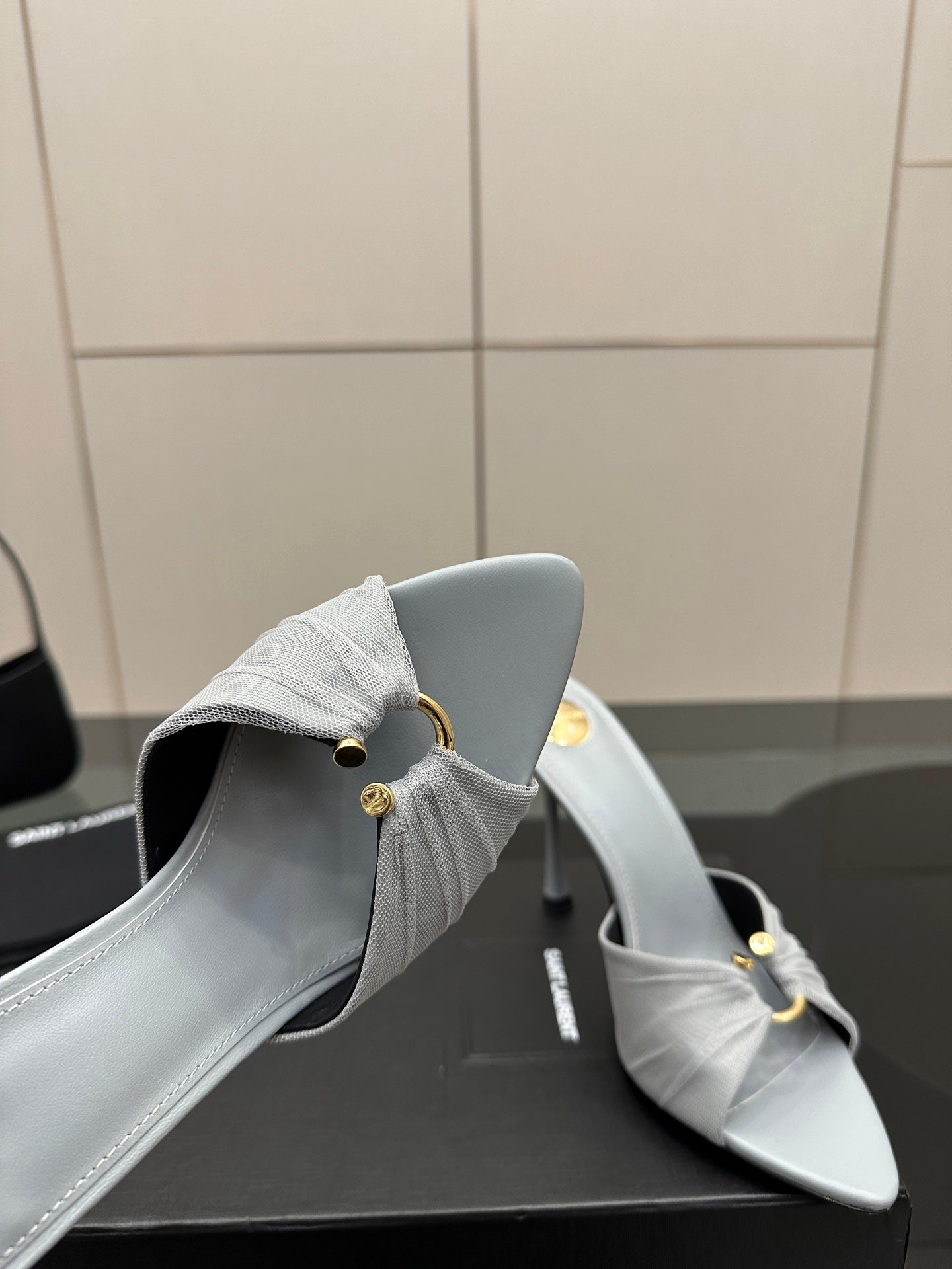 Women’s YSL light blue mule sandals, close-up of back strap and stiletto heel