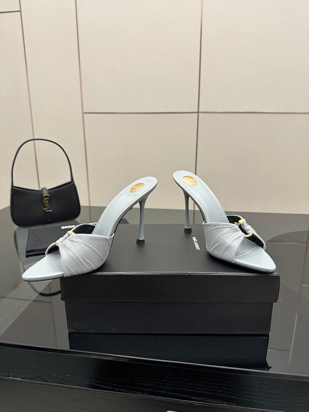 Women’s YSL light blue mule sandals with thin stiletto heels and gold hardware strap