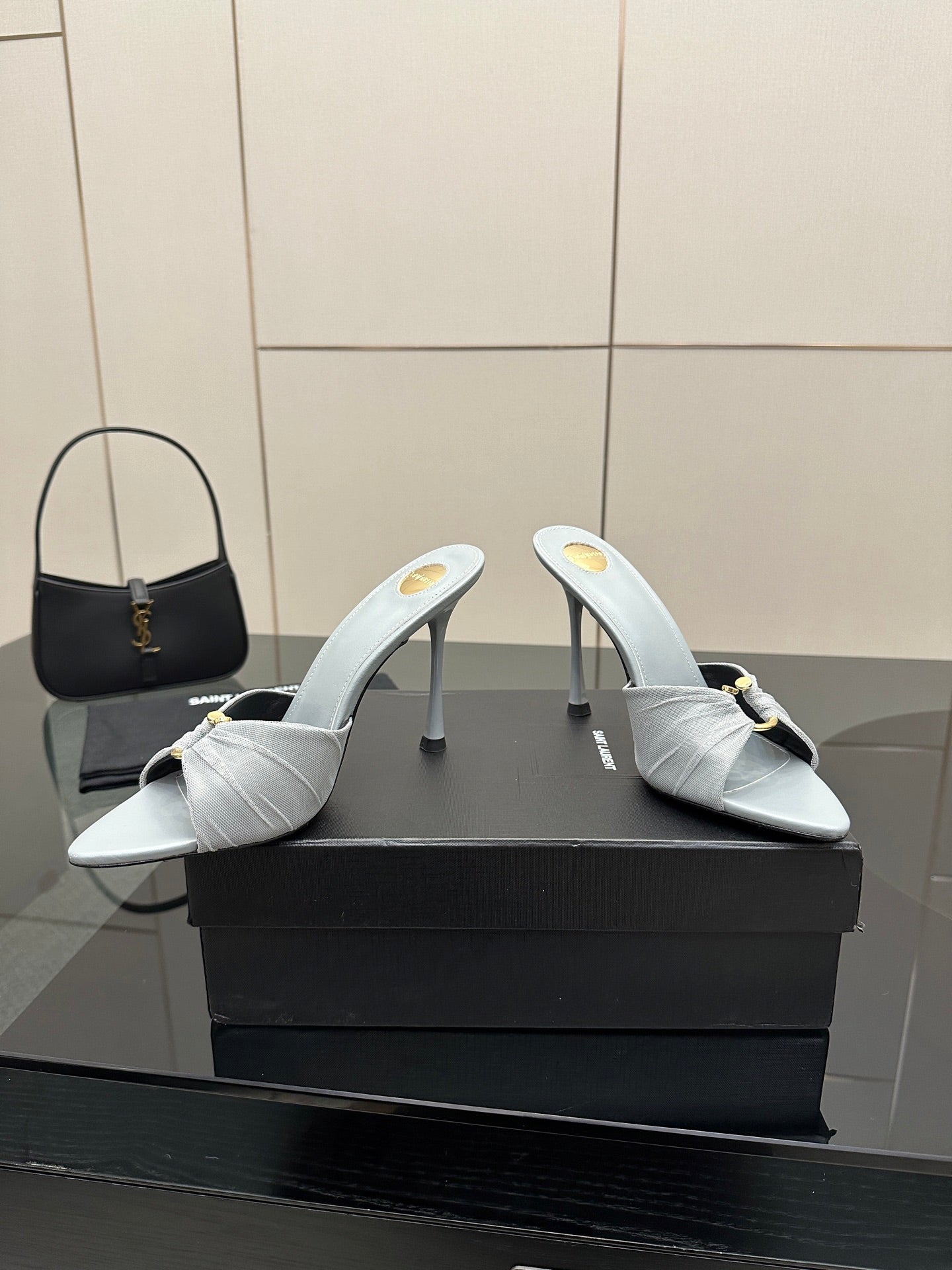 Women’s YSL light blue mule sandals with thin stiletto heels and gold hardware strap