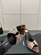 YSL ladies mule sandal close-up of open toe and bow strap with leopard-pattern backing