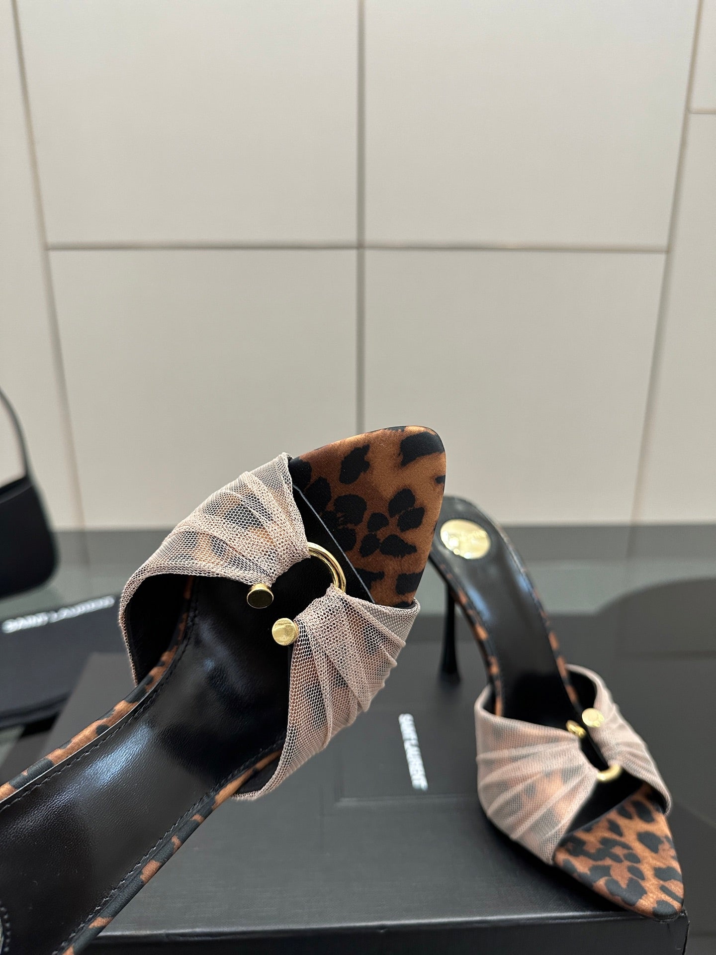 YSL ladies mule sandal close-up of open toe and bow strap with leopard-pattern backing