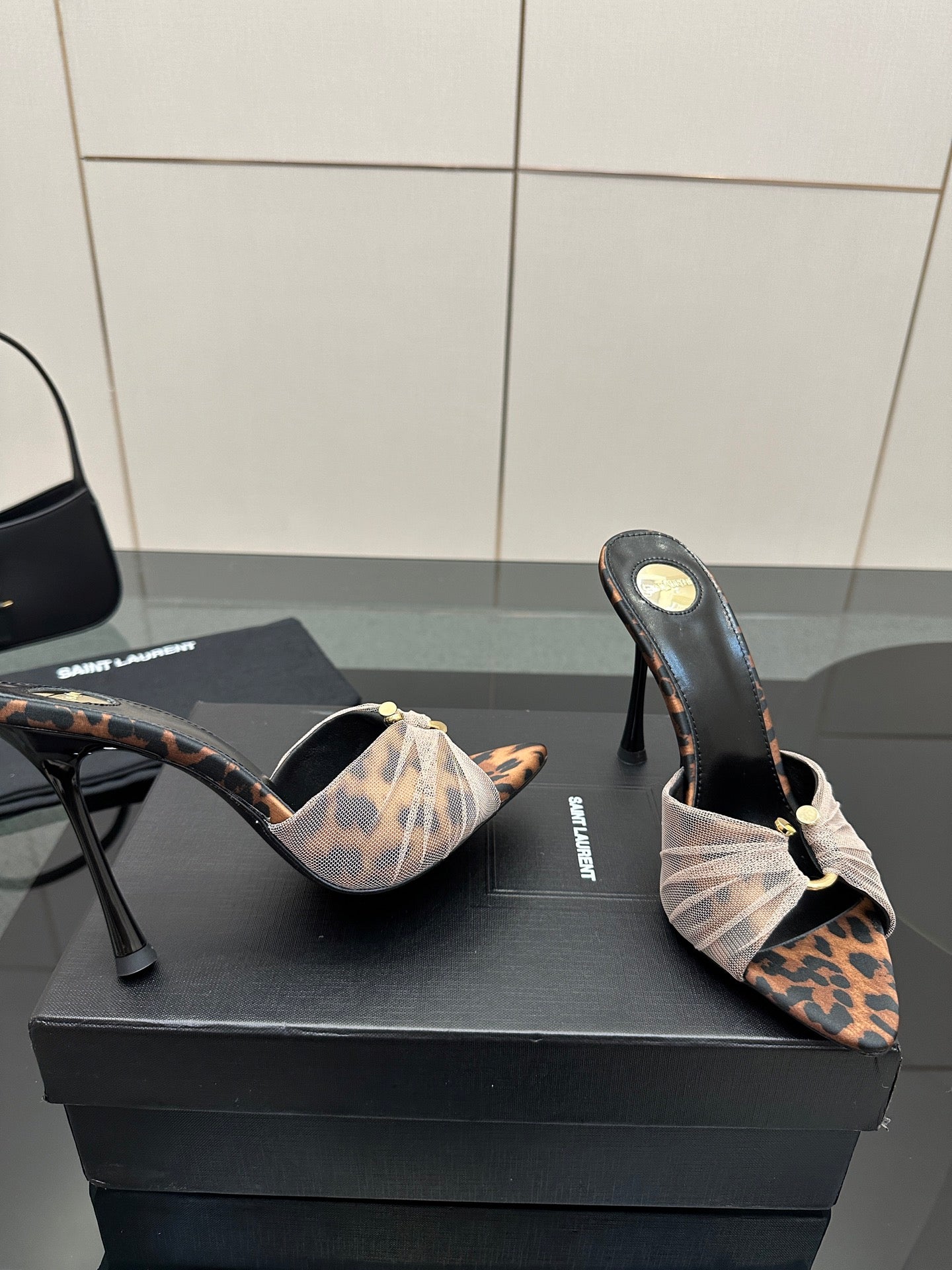 YSL ladies heeled mule sandals viewed from side, leopard print and bow strap design