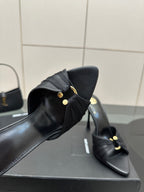 Black leather mule upper with gold button hardware and tall stiletto heel