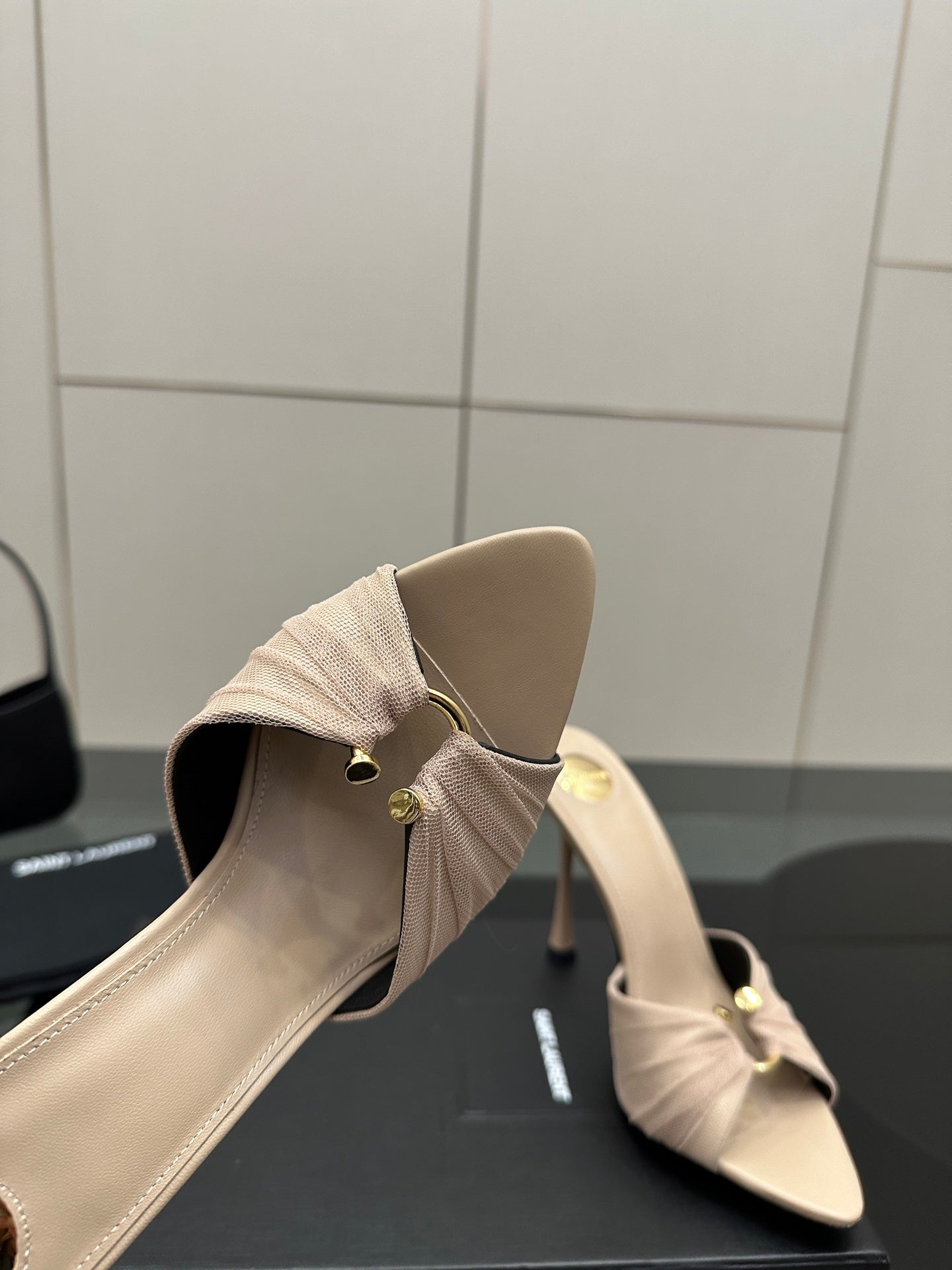 Cream mule sandal with bow at side and slim stiletto heel, heel and sole detail.