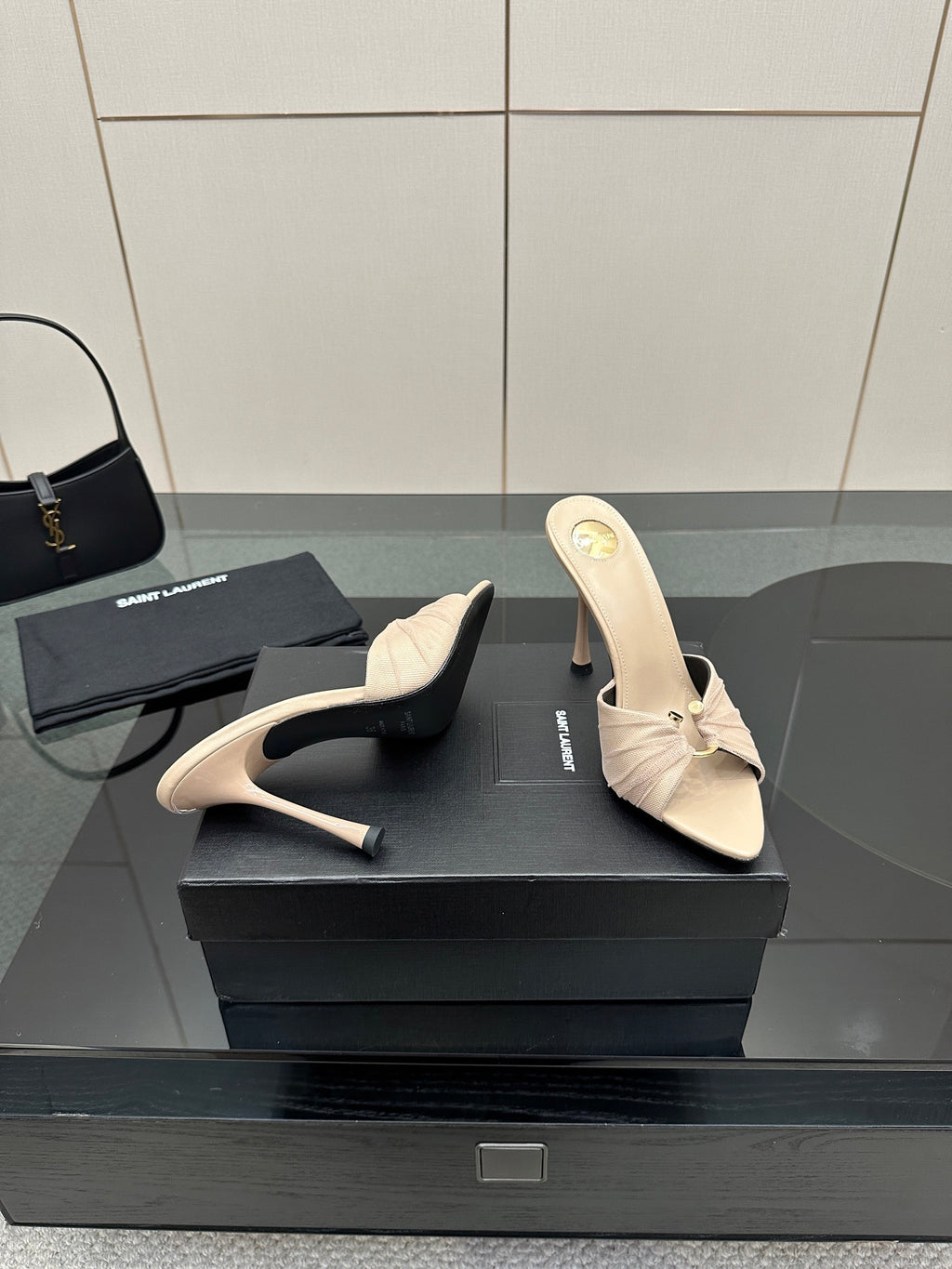 Cream heeled mule sandals with bow and open back, pair on display.
