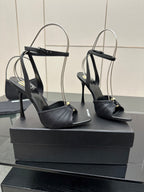 Black open-toe stiletto heeled sandals with ankle strap, shown from side angles