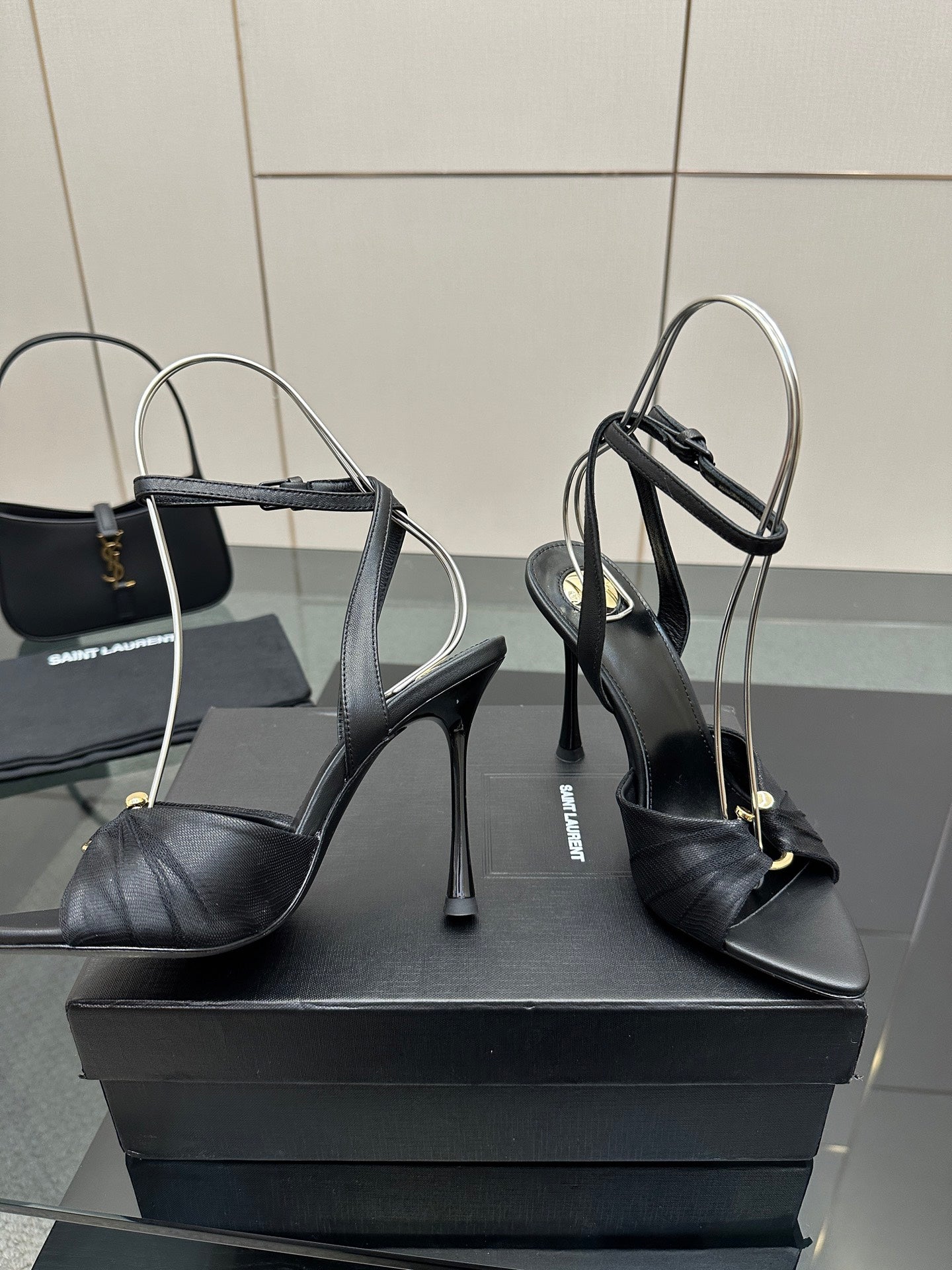 Black strappy stiletto heeled sandals with peep toe and ankle buckle strap