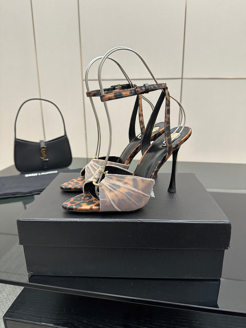 YSL ladies peep-toe stiletto sandals with multi-color patterned straps and ankle bow