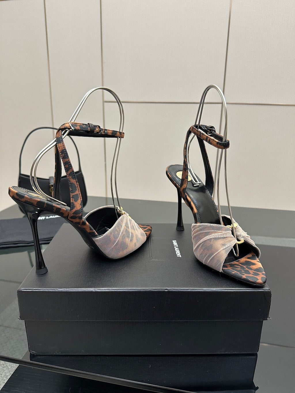 YSL ladies peep-toe stiletto sandals with thin straps and bow at ankle, side angle