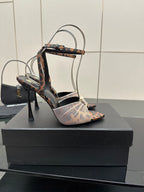 YSL ladies peep-toe stiletto sandal on black box, patterned straps and ankle bow