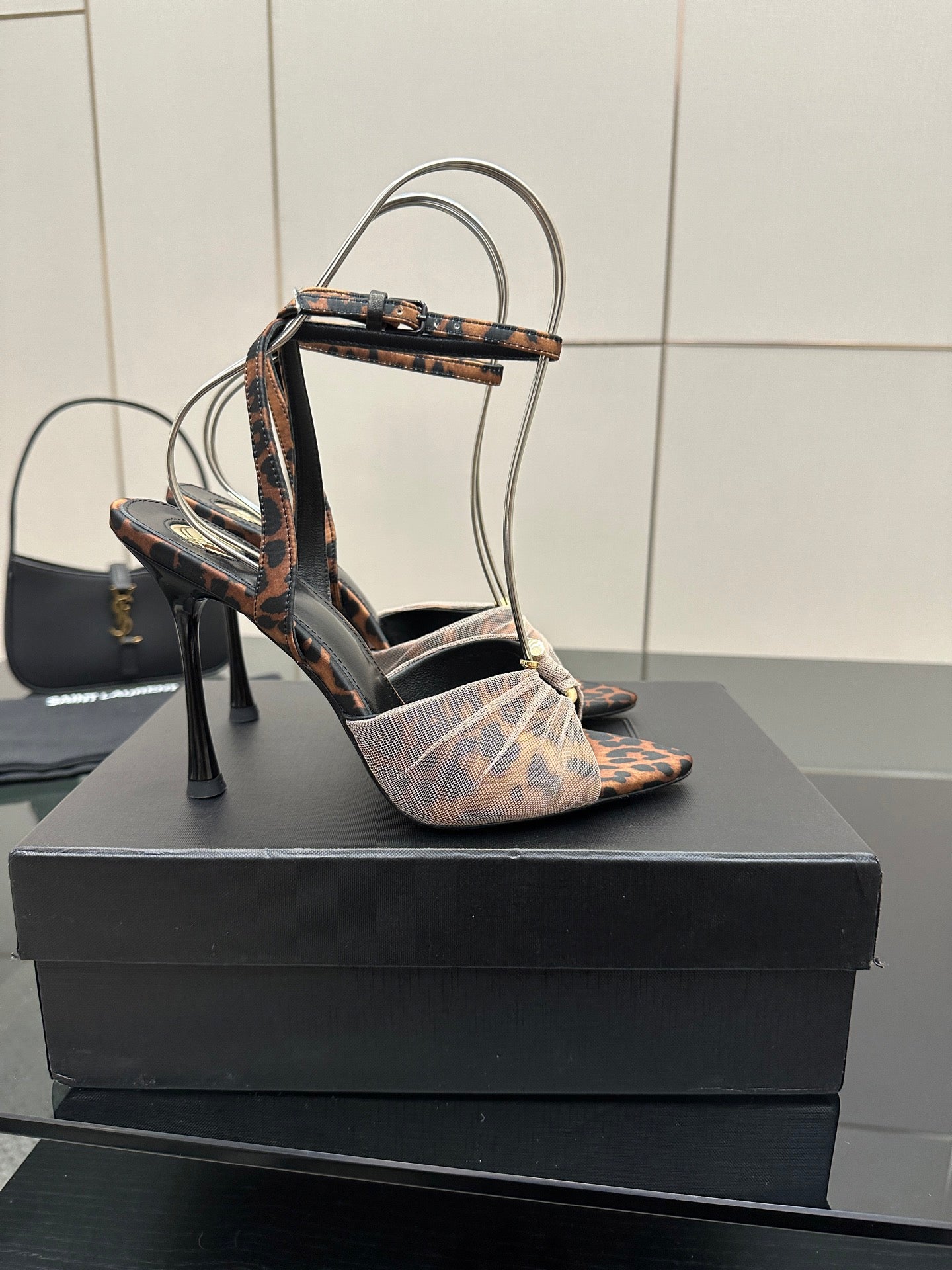 YSL ladies peep-toe stiletto sandal on black box, patterned straps and ankle bow