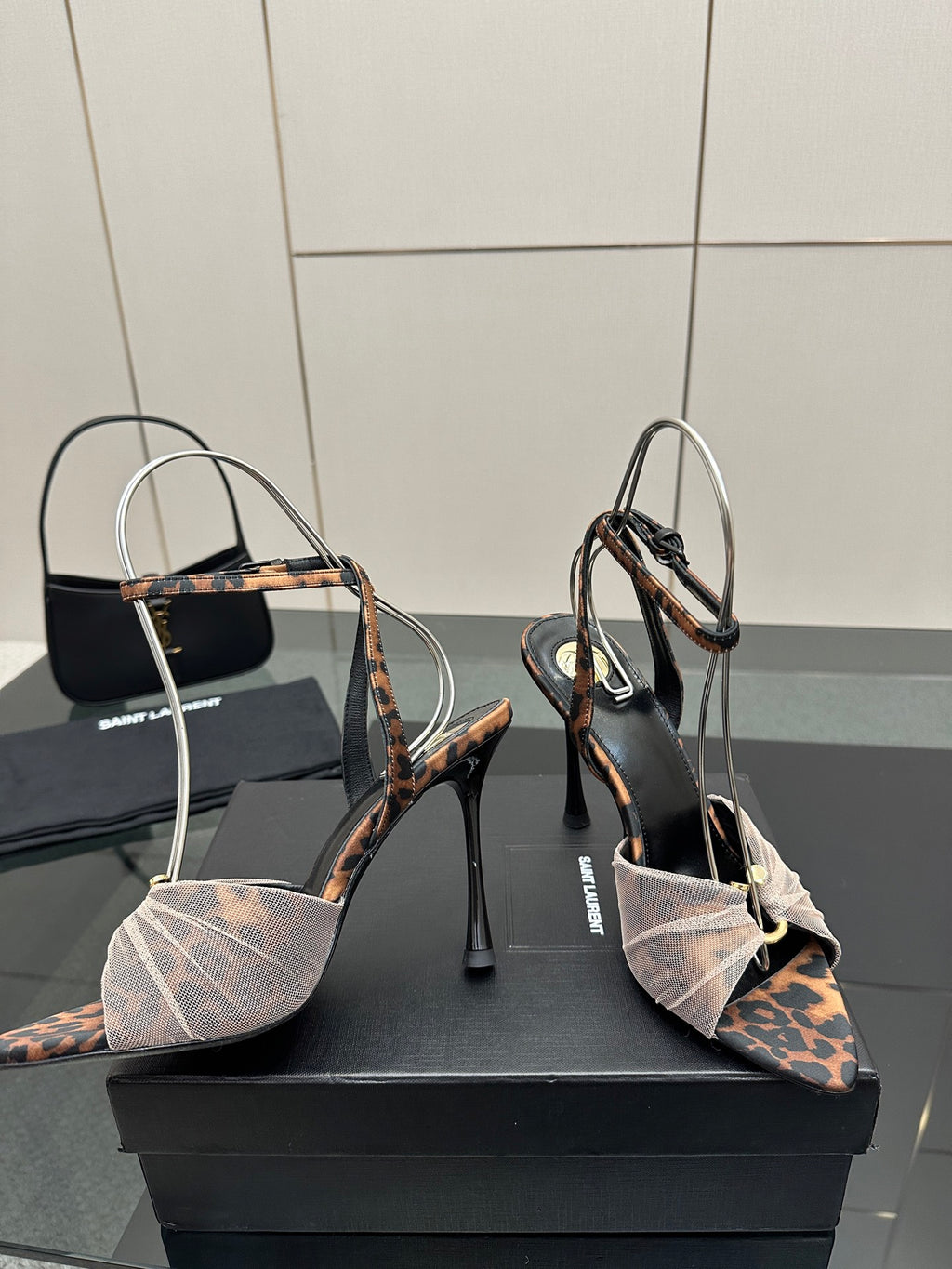 YSL ladies peep-toe stiletto sandals showing patterned heel straps and ankle bow detail