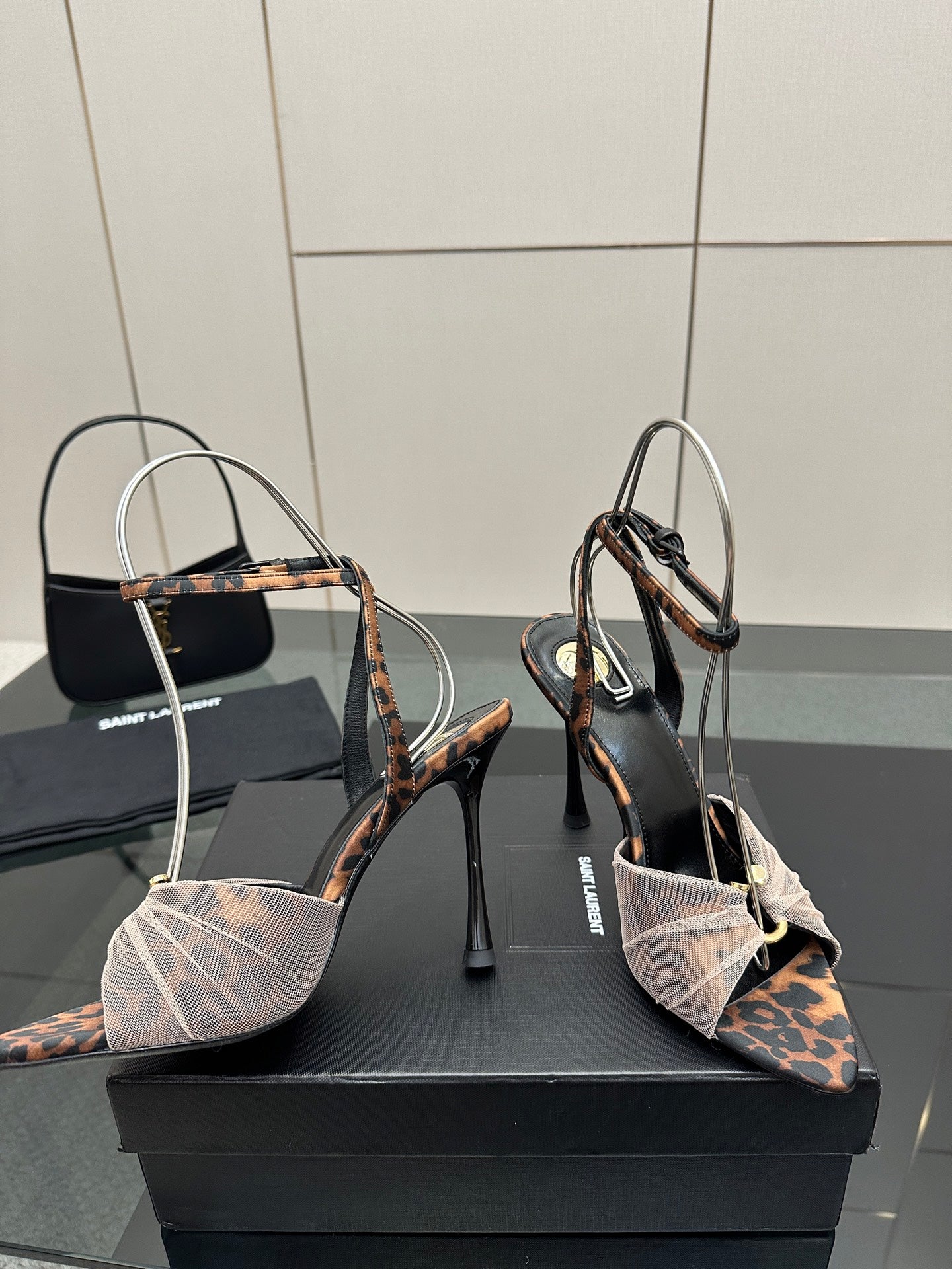YSL ladies peep-toe stiletto sandals showing patterned heel straps and ankle bow detail