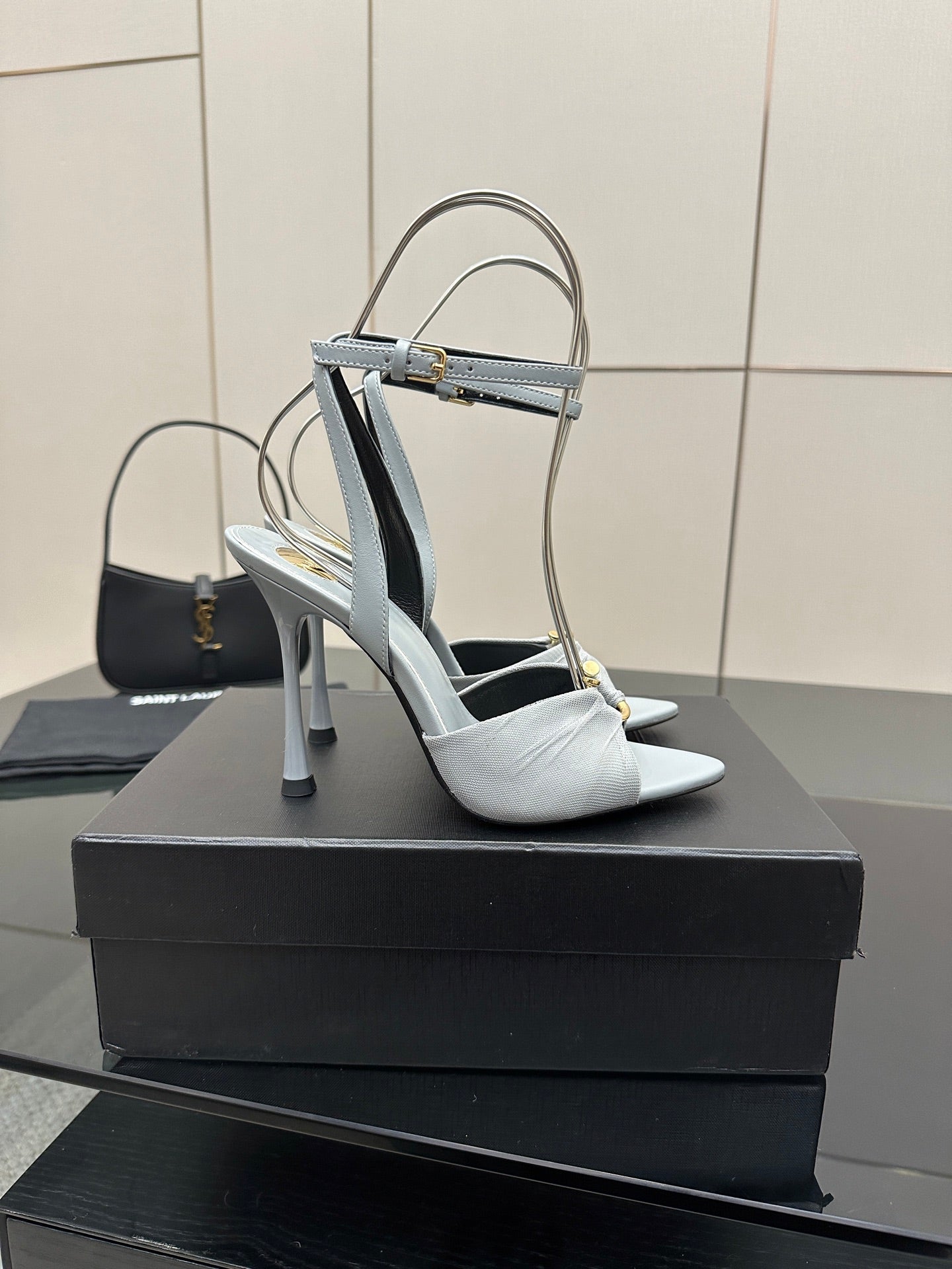 Women’s light-blue peep-toe heeled sandals with ankle strap and stiletto heel, front view