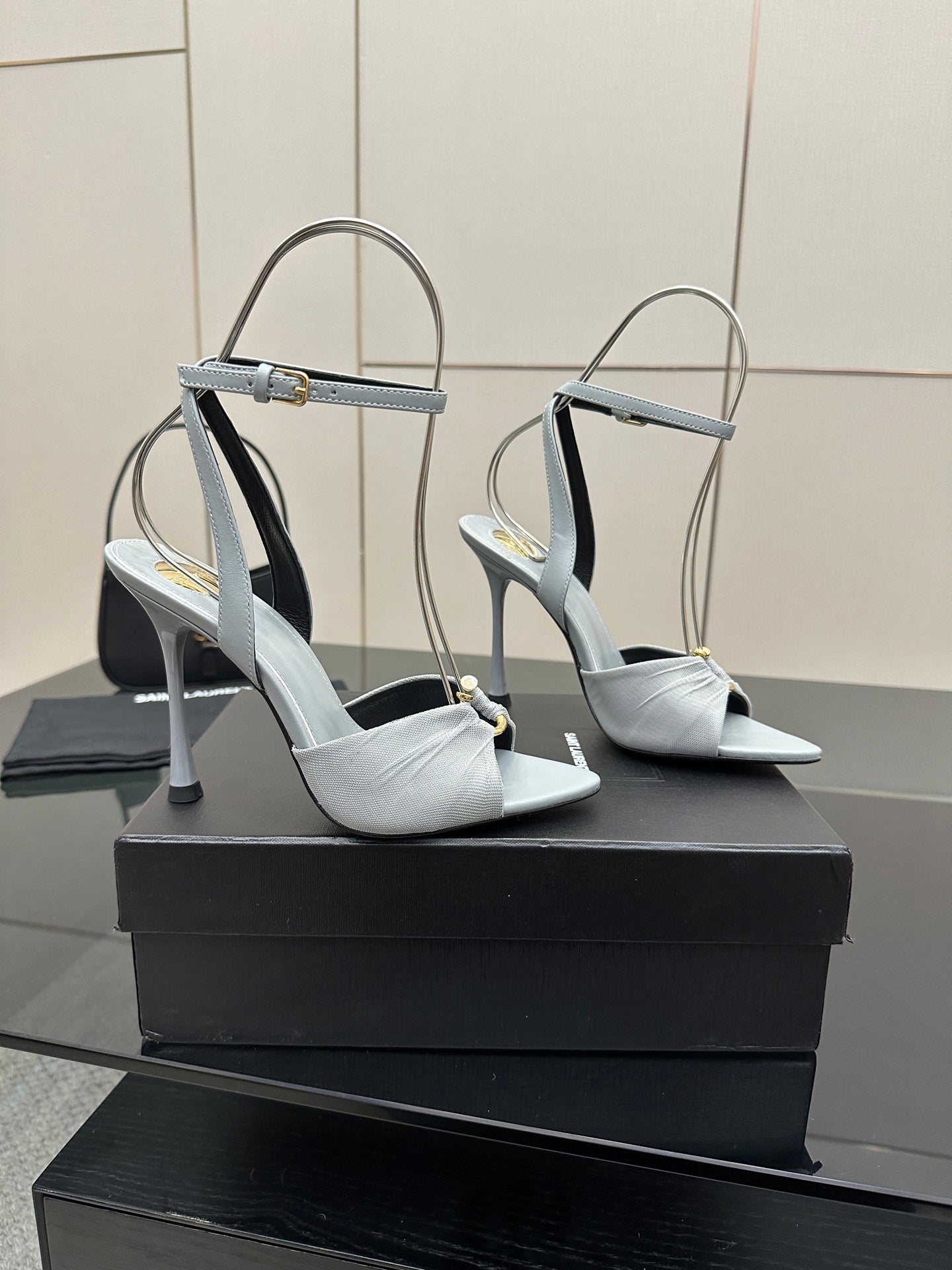 Pair of women’s light-blue peep-toe heeled sandals with ankle strap and stiletto heel