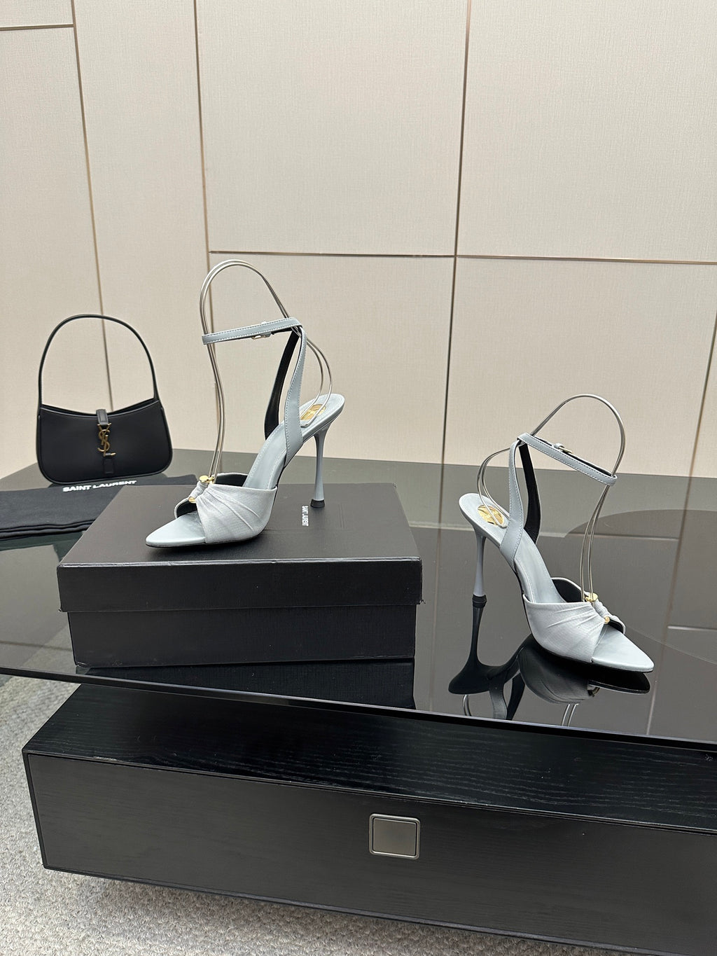 Women’s light-blue peep-toe heeled sandals with ankle strap and stiletto heel, on display