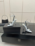 Women’s light-blue peep-toe heeled sandals with ankle strap and stiletto heel, on display