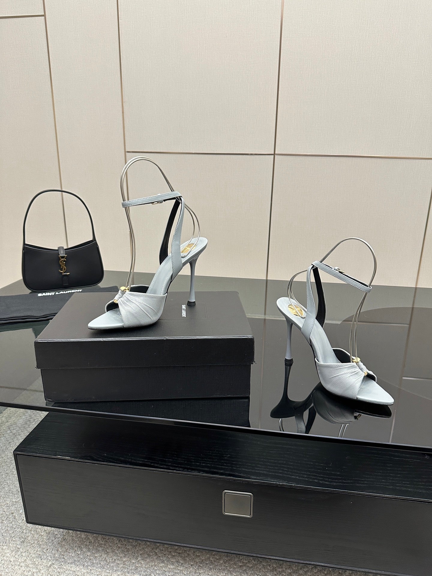 Women’s light-blue peep-toe heeled sandals with ankle strap and stiletto heel, on display