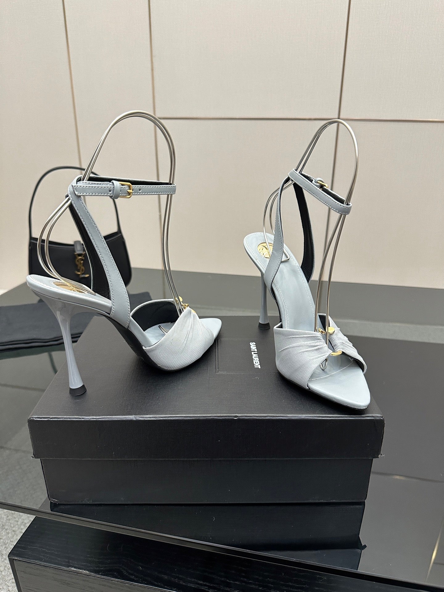 Women’s light-blue slingback heeled sandals with ankle strap and stiletto heel, side view