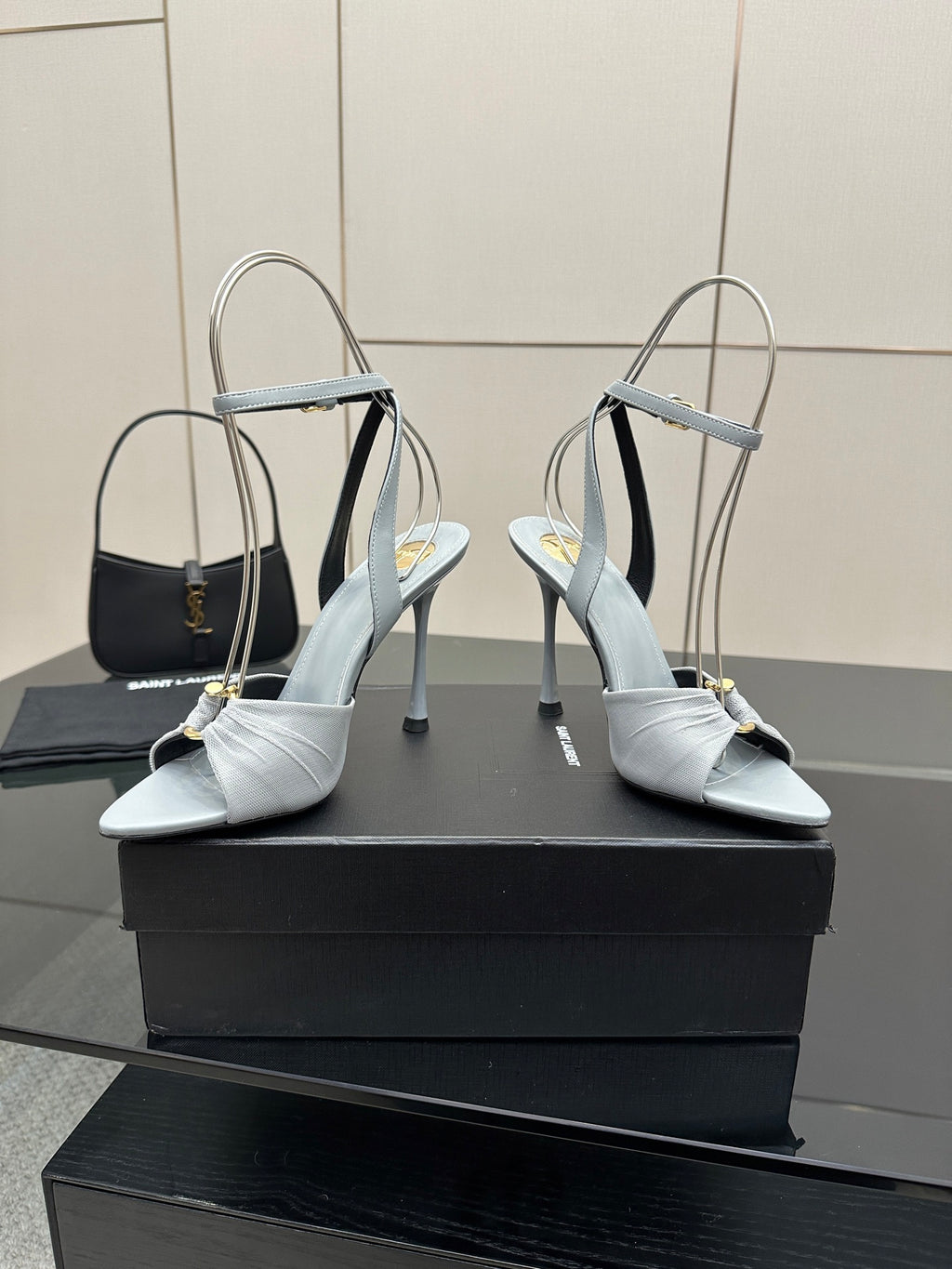 Women’s light-blue peep-toe heeled sandals with ankle strap, glossy buckle, and stiletto heel
