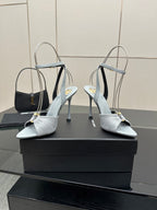 Women’s light-blue peep-toe heeled sandals with ankle strap, glossy buckle, and stiletto heel