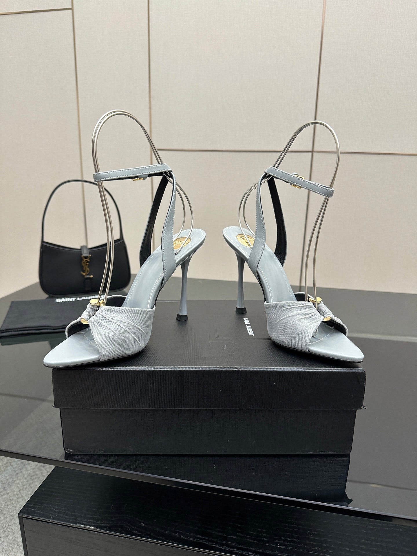 Women’s light-blue peep-toe heeled sandals with ankle strap, glossy buckle, and stiletto heel