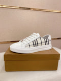 White Burberry low-top sneakers with black check stripe and lace-up front