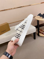 White Burberry sneaker viewed from the side with black check fabric panel