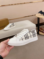 White Burberry sneaker with black check stripe upper and thick white rubber sole