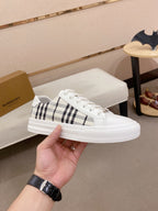 White Burberry low-top sneaker with black check stripe and lace-up closure