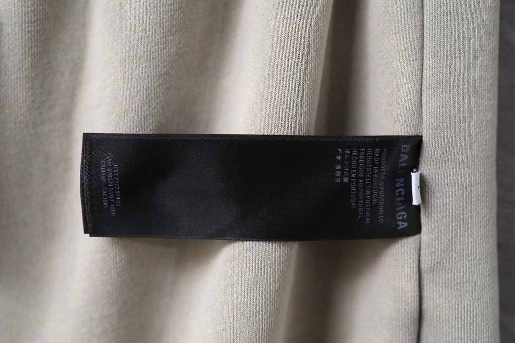 Beige shorts with black inner label tag near waistband