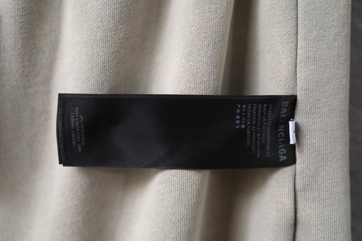Beige shorts with black inner label tag near waistband