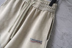 Beige shorts with elastic waistband and hanging drawstrings