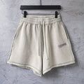 Beige drawstring shorts with elastic waistband and side pockets