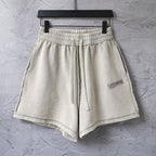 Beige drawstring shorts with elastic waistband and side pockets