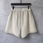 Beige drawstring shorts with elastic waist and relaxed wide legs